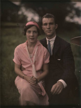 This vintage photograph depicts a couple from a past era, providing a glimpse into the historical fashion and relationship dynamics of an earlier time period.