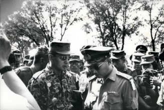 Feb. 24, 2012 - Grief exchanged - Maj. General Suharto (left) newly appointed Army Chief of Staff in Indonesia, talks with fellow officer outside Army Headquarters in Djakarta prior to funeral service...