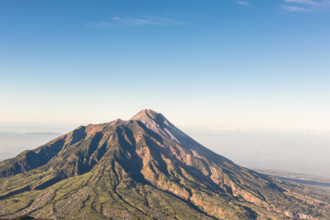 A view of Merapi volcano from the Merbabu volcano near the touristic city of Yogyakarta  in central  Java in Indonesia