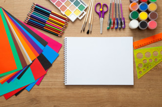 set of school supplies with pencil, colored pen, watercolor paint, notebook and scissors