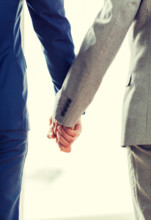 close up of male gay couple holding hands