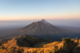 Stunning sunrise over the Merapi volcano and the countryside around Yogyakarta in entral Java in Indonesia from the top of the M