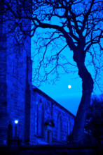 Old church at night under full moon