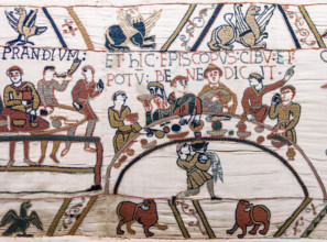 Scene 43 of the Bayeux Tapestry depicts a banquet, possibly celebrating William the Conqueror's victory. The embroidery illustrates medieval dining customs, with figures feasting at a table, emphasizi...