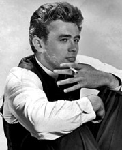 This image likely features James Dean, the iconic American actor, known for his roles in films such as 'Rebel Without a Cause.' The photograph captures him in a relaxed or candid moment, holding a cig...