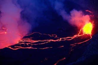 Lava and steam in crater of Nyiragongo volcano in Virunga National Park in Democratic Republic of Congo, Africa. Picture taken during dusk with blue c