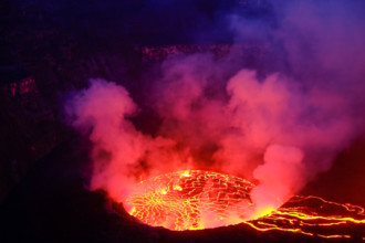 Lava and steam in crater of Nyiragongo volcano in Virunga National Park in Democratic Republic of Congo, Africa. Picture taken during dusk with blue c