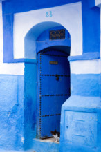 Chefchaouen, Morocco; street in the old town with typical blue-painted walls and doors