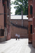 Senior couple walking with hand to hand in Venice - Health concept - style life & activity.