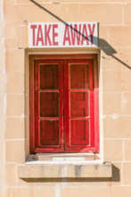 Red window and shutters with a sign above saying "Take Away"