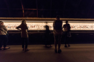 Bayeux, France. Visitorswalk past the famous tapestry (Tapisserie) of Bayeux,1000 year old carpet telling the story of the Norman conquest of England