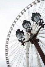 The Big Wheel at Place de la Concorde and a street lamp in the foreground in Paris. France