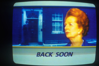 Mrs Margaret Thatcher as seen on ITN news, her resignation on 22 11 1990. Image 10 Downing Street background. Inset portrait of the Prime Minister, commercial advertising beak  "Back Soon". 1990 1990s...