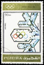 MOSCOW, RUSSIA - MARCH 23, 2019: Postage stamp printed in United Arab Emirates, Fujairah, shows Innsbruck 1964, Winter Olympics 1924-1972, Advertising