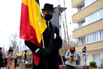 Brussels, Belgium. 22nd Mar, 2021. People pay a tribute in the monument for the victims of the 2016 three suicide bombings on the fifth anniversary of the attacks, in central Brussels, Belgium March 2...