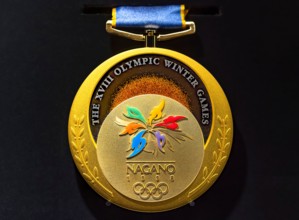 tokyo, japan - march 2 2021: Close up on the official gold medal used during the 1998 Winter Olympics of Nagano exhibited in the Japan Olympic Museum.