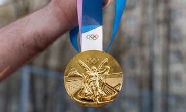 April 17, 2021 Beijing, China. Olympic gold medal in the hand of an athlete.