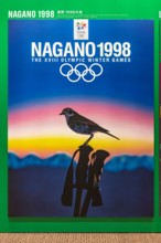 tokyo, japan - august 10 2021: Japanese poster of Nagano 1998 winter olympics games depicting a thrush perched on a ski pole with mountains