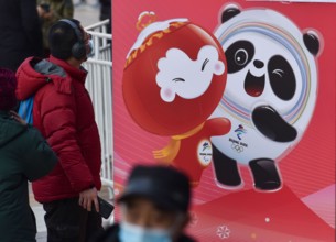 Beijing, China. 10th Feb, 2022. A pedestrian seen looking at the giant poster of Bing Dwen Dwen in Wangfujing Street. The 24th Winter Olympic Games have been held in February 2022 in Beijing, China. T...