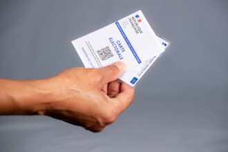 Woman holding a French electoral and identity card, elections in France