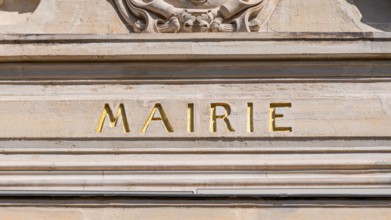 Sign saying 'Town hall' written in French on the facade of a city hall. Concepts of municipal elections, local politics and administration in France