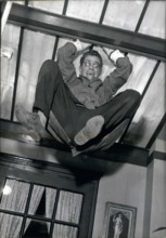 Aug. 17, 1960 - Darry Cowl is pictured in a funny scene in which he hangs from the ceiling in Jacques Poitrenaud's movie ''Paris Loves'