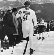 Sixten Jernberg, a Swedish cross-country skier, is shown during the 1964 Winter Olympics in Innsbruck, where he earned a notable place in Nordic skiing history with his exceptional performance.