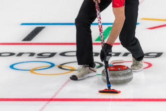 Detail of curling broom and stone at the Olympic Winter Games PyeongChang 2018