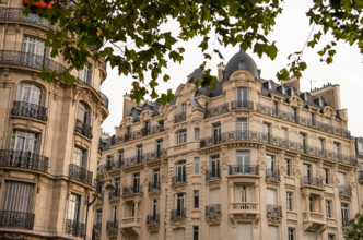 Eiffel tower between Parisian tenement old street alley and buildings, Paris
