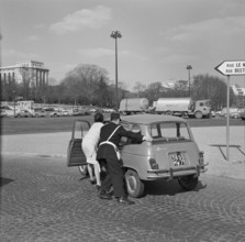 Pariser Bilder [The street life of Paris] Description: Car pushed by traffic cop and driver Date: 1965 Location: France, Paris Keywords: cars, street images, traffic police