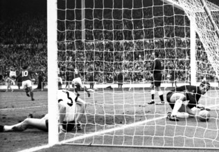 England versus West Germany 1966 World Cup Final, Wembley Stadium England's Martin Peters turns to celebrate his 18th minute goal with Geoff Hurst and Roger Hunt as West Germany's Hans Tilkowski picks...
