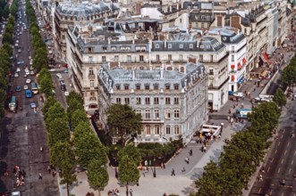 View from the top of the Arc de Triomphe in Paris with the Avenues De Friedland and Charles de Gaulle. Pedestrians crossing busy roads.  Archival shot