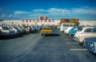 1970s archive image of car park in front of a Carrefour hypermarket in the South of France.  Believed to be Carrefour La Ciotat.