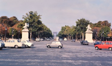Cars on the Champs Elysees in Paris France, the Arch de Triomphe in the background ca. 1976