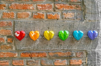 Rainbow flag decoration on brick wall, pride month concept
