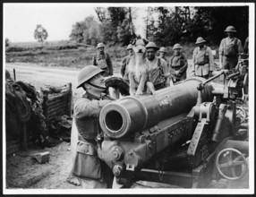 A dog sits triumphantly atop a field gun surrounded by gunners during World War I in France. The image captures a rare moment of levity amid the harsh realities of war. Animals, including dogs, were o...