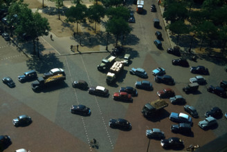 Vintage 1960's Paris France traffic as from the Arc de Triomphe looking down on the Place Charles de Gaulle
