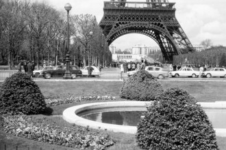 This photograph of the Eiffel Tower taken in 1965 captures the iconic structure in a timeless image, symbolizing both the engineering marvel and cultural significance of Paris. The Eiffel Tower, compl...