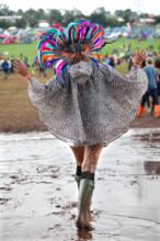 A young woman struggles through the mud at the 2014 Glastonbury Festival.