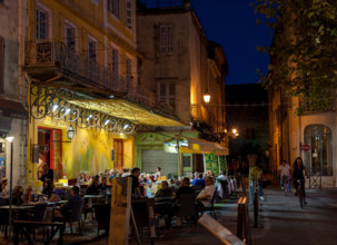 Café Van Gogh in Arles, Provence-Alpes-Cote d'Azur, France - September 15, 2010: Warm summer evening in café at the Place du Forum