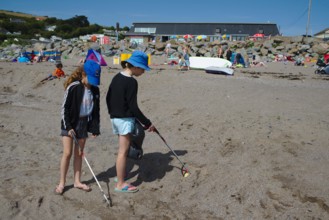 Beach clean up children help by volunteering to do five minutes of litter picking at Chalisborough. Devon UK