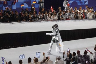 July 26th, 2024 - Paris, France: the Horsewoman wearing a silver and black armour (Floriane Issert) presents the Olympic Flag at Place du Trocadero du