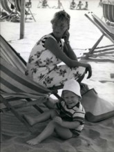 1968 - Paola di Liegi and her family at the beach of Marina di Massa, where they will stay for two months. The little Phillipe enjoys himself on the beach, while his sister Princess Astrid, sleeps on ...