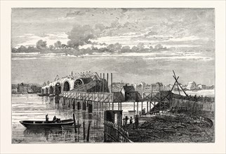 BLACKFRIARS OLD BRIDGE DURING ITS CONSTRUCTION, SHOWING THE TEMPORARY FOOT BRIDGE. From a Print of