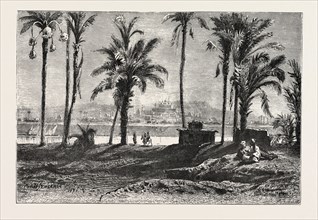 NEAR GIZEH, BETWEEN THE NILE AND THE PYRAMIDS.  Egypt, engraving 1879
