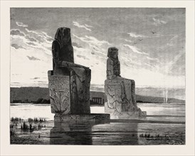 The statue of Memnon and its companion at the time of high Nile. Egypt, engraving 1879