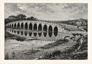 THE MARBLE BRIDGE OF SEVENTEEN ARCHES LEADING TO THE ISLAND IN THE LAKE OF ONANE-CHEON-CHANE, CHINA