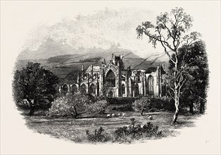 MELROSE ABBEY, FROM THE SOUTH-EAST. Melrose Abbey is a Gothic-style abbey in Melrose, Scotland. It