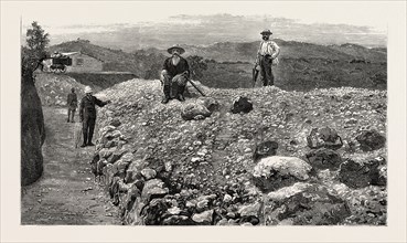 MASS OF QUARTZ EXCAVATED FROM NO. 5 TUNNEL IN THE ELIZABETH LODE, MINERS QUARTERS IN THE DISTANCE,