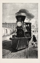 AN AMERICAN LOCOMOTIVE ENGINE AND COW CATCHER, 1873 engraving